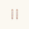 Gold pavé hoop earrings with two freshwater pearls nestled inside the curved design, featuring crystal-studded outer edge.