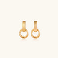 Gold stud earrings with vertical ridged bar connecting to triple interlocking circular rings on white background