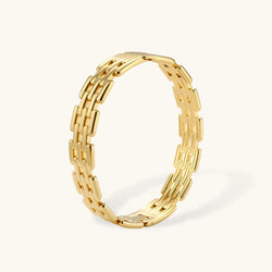Wide 18K gold plated stainless steel bracelet with a multi-row rectangular grid link chain pattern on a cream background.